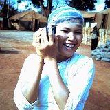 "Hootch Maid in old ABtry 6/27th Arty Admin Area - Quan Loi March 68 - EM Club in Center Background"